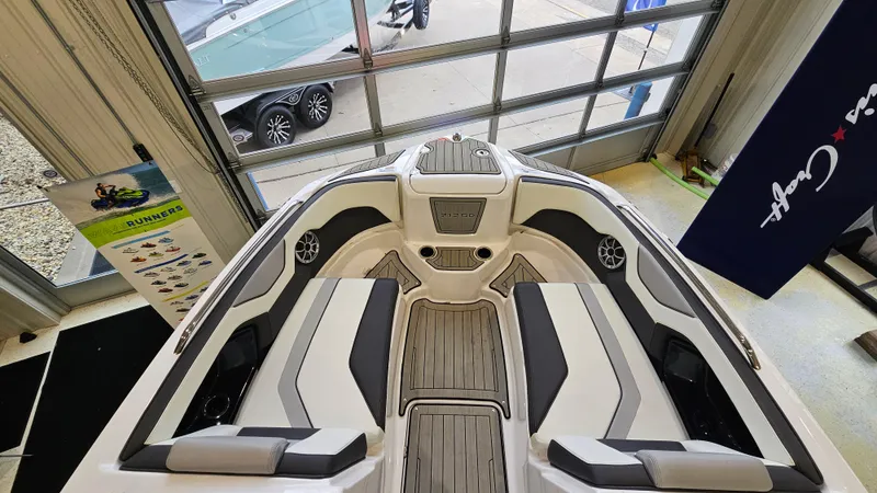 Slide: The Image of Interior view of 2021 Yamaha Boats 212SD, showcasing seating and deck design. - 20