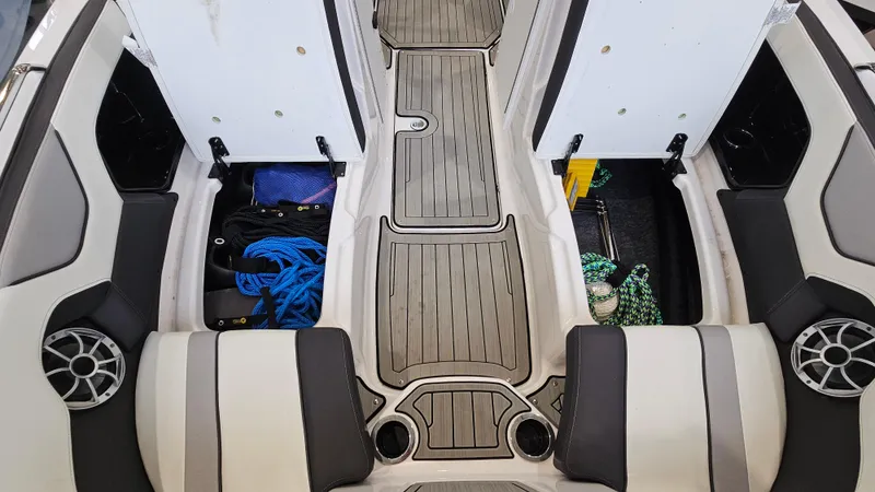 Slide: The Image of 2021 Yamaha Boats 212SD interior with open storage compartments and seating. - 26