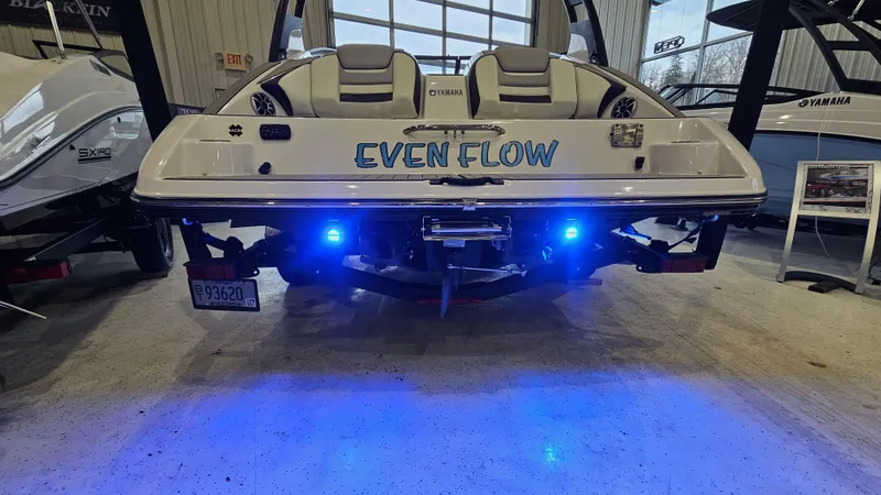 Slide: The Image of 2021 Yamaha Boats 212SD with blue underwater lights, displayed indoors. - 5