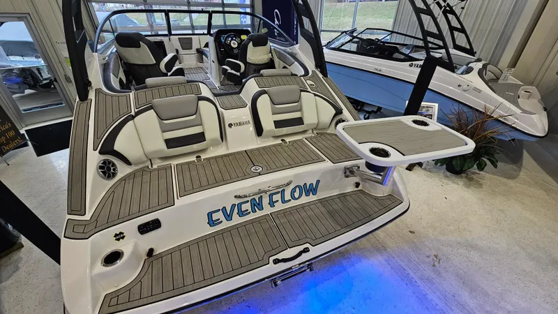 Slide: The Image of 2021 Yamaha Boats 212SD with custom "Even Flow" design, displayed indoors. - 6