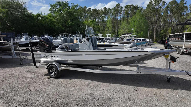 Slide: The Image of 2025 Xpress H20B boat on trailer in outdoor showroom. - 0