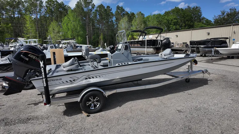 Slide: The Image of 2025 Xpress H20B boat on trailer in outdoor dealership lot. - 10