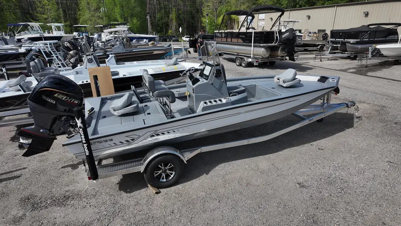 Slide: The Image of 2025 Xpress H20B boat in a dealership lot, surrounded by various other boats. - 11