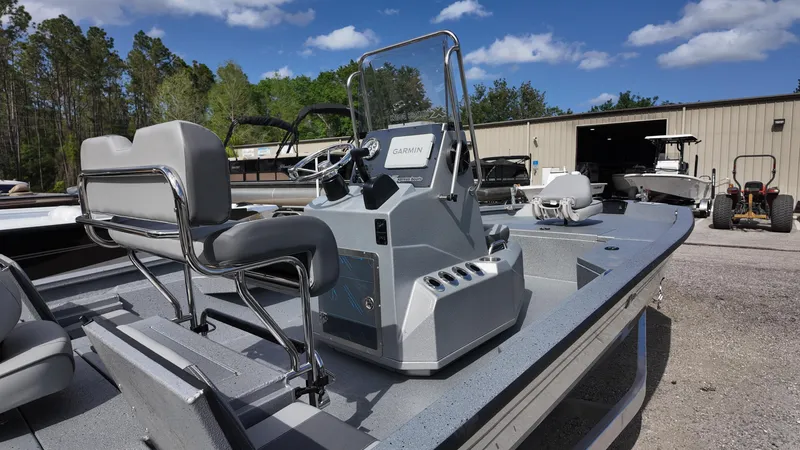 Slide: The Image of 2025 Xpress H20B boat with sleek design, parked outdoors under a clear blue sky. - 16