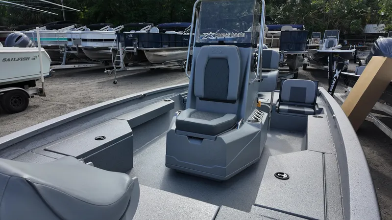 Slide: The Image of 2025 Xpress H20B boat with sleek seating and console, displayed in a marina setting. - 21