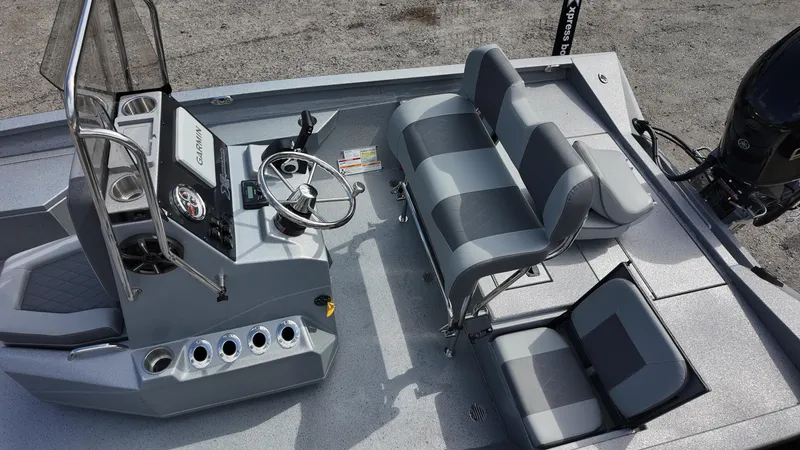 Slide: The Image of 2025 Xpress H20B boat interior with gray seating and steering console. - 25