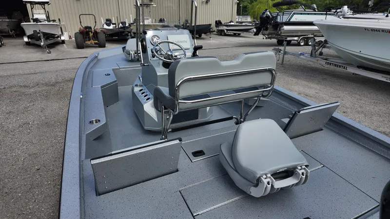 Slide: The Image of 2025 Xpress H20B boat interior with gray seating and steering console. - 26