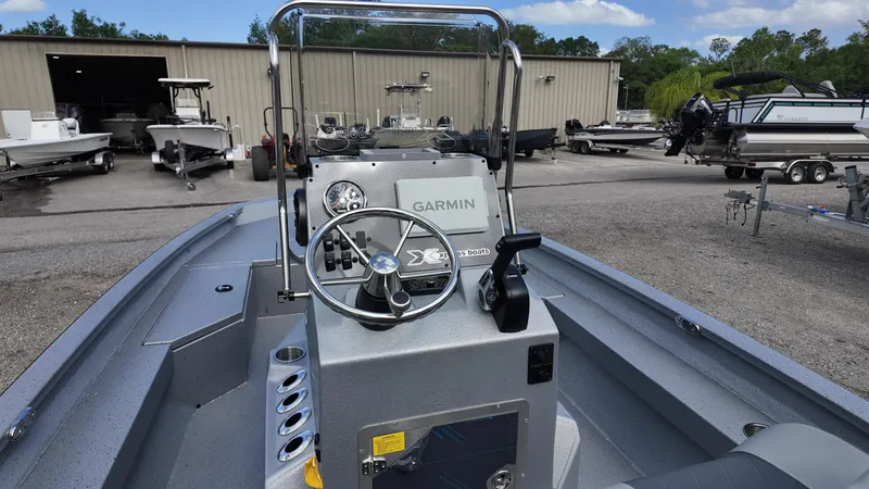 Slide: The Image of 2025 Xpress H20B boat with Garmin navigation, parked in a boatyard. - 28