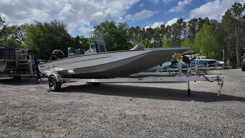 Slide: The Image of 2025 Xpress H20B boat on trailer, parked outdoors under cloudy sky. - 3
