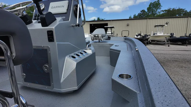 Slide: The Image of 2025 Xpress H20B boat interior with Garmin equipment, parked outdoors under a blue sky. - 30