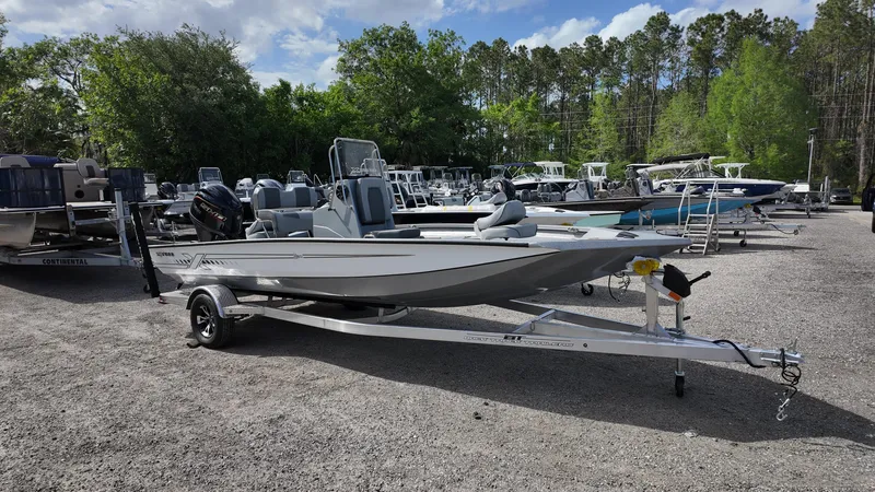 Slide: The Image of 2025 Xpress H20B boat on trailer in outdoor dealership lot. - 4