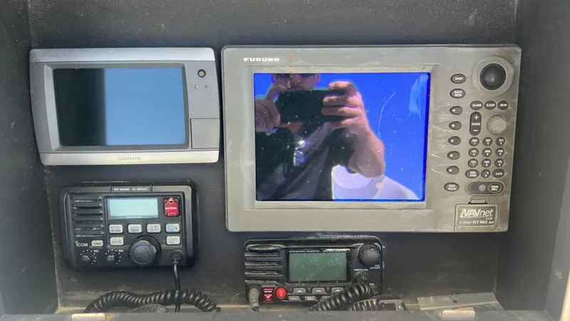 Slide: The Image of Control panel of a 2005 Contender 36 boat with navigation and communication devices. - 10