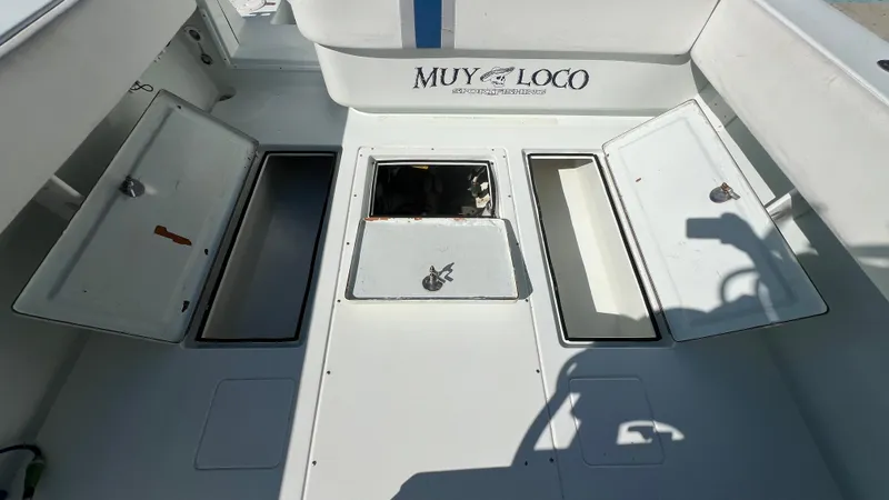 Slide: The Image of 2005 Contender 36 boat deck with open storage compartments, labeled "Muy Loco." - 13