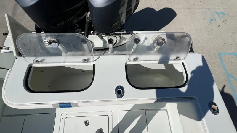 Slide: The Image of 2005 Contender 36 boat with open storage compartments and dual outboard motors. - 14