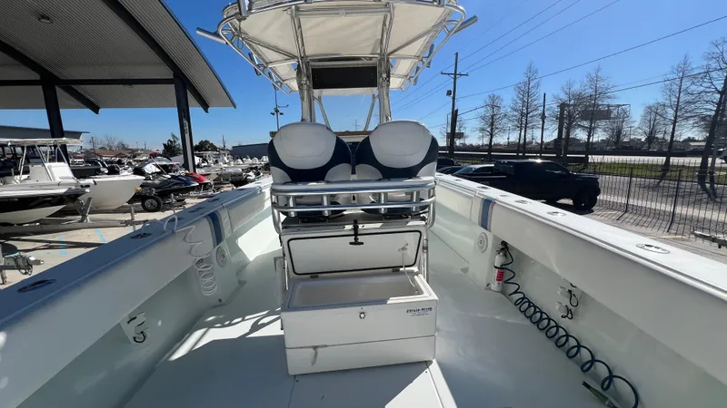 Slide: The Image of 2005 Contender 36 boat interior with open storage, helm seating, and canopy. - 17