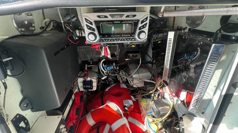 Slide: The Image of 2005 Contender 36 boat electronics and wiring with life jackets in storage compartment. - 20