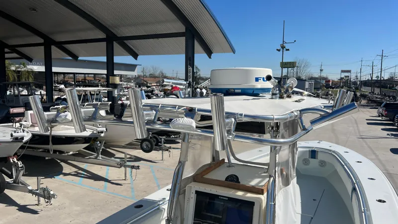 Slide: The Image of 2005 Contender 36 boat in marina, featuring radar equipment and rod holders under a clear blue sky. - 27