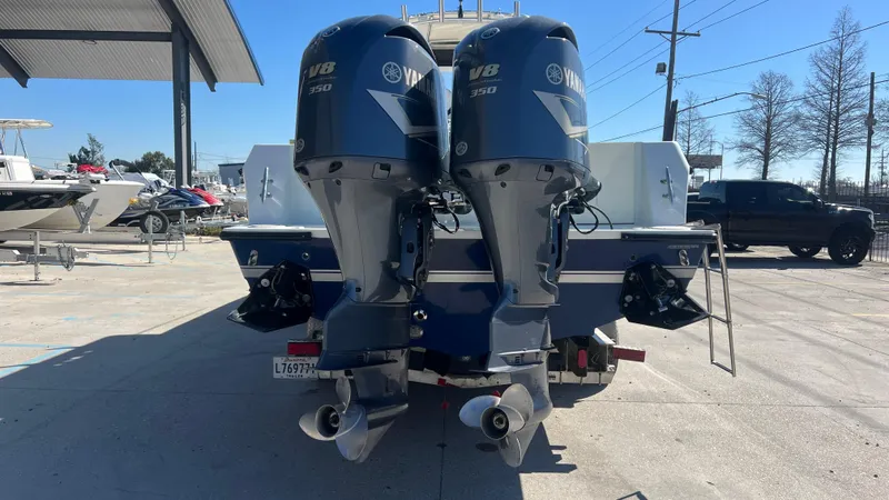 Slide: The Image of Twin Yamaha outboard engines on a 2005 Contender 36 boat, parked outdoors. - 3