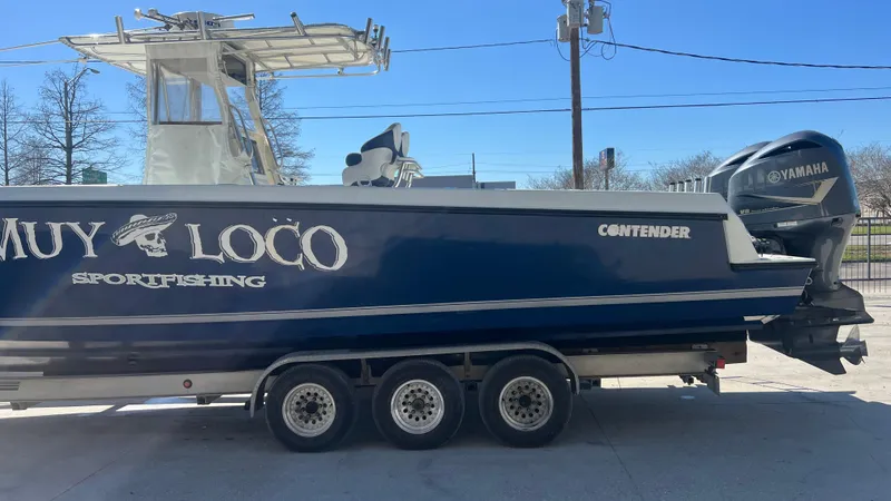 Slide: The Image of 2005 Contender 36 sportfishing boat on trailer, featuring Yamaha engines. - 6