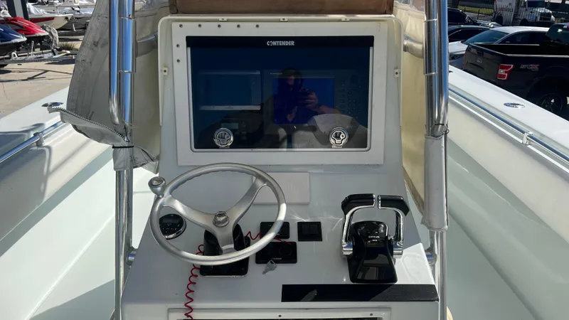 Slide: The Image of 2005 Contender 36 boat dashboard with steering wheel and controls. - 8