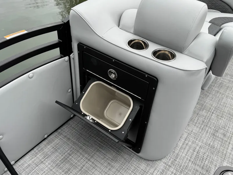 Slide: The Image of 2025 JC Neptoon Sport 23TT DSL boat interior with cup holders and storage compartment. - 16