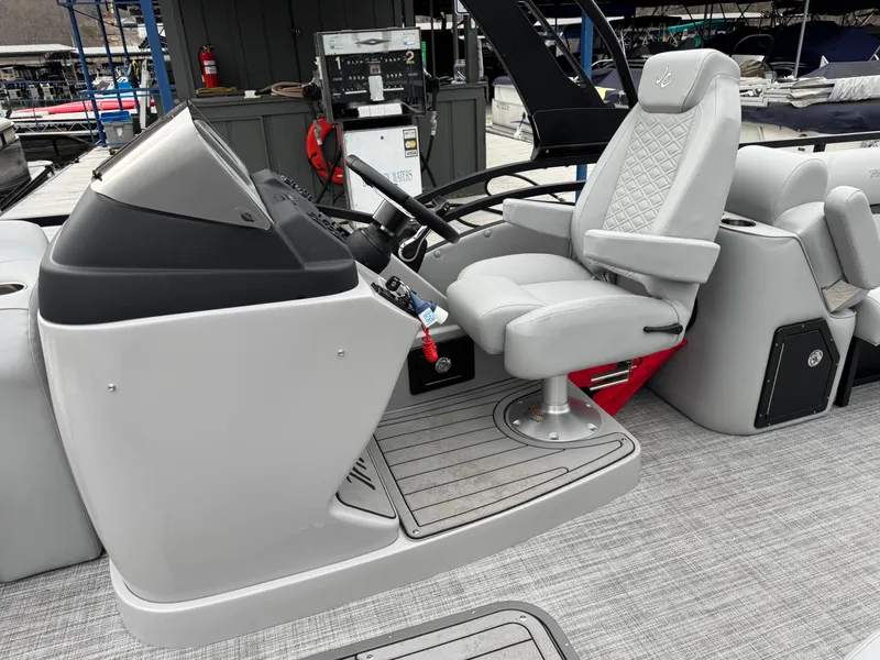 Slide: The Image of Captain's seat of 2025 JC Neptoon Sport 23TT DSL boat, featuring modern controls and design. - 17