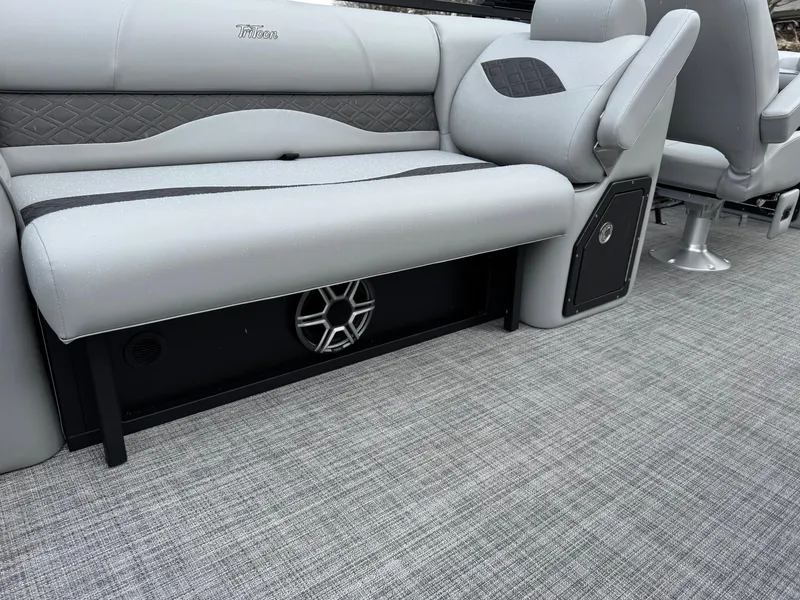 Slide: The Image of 2025 JC Neptoon Sport 23TT DSL boat interior with gray seating and speaker system. - 2