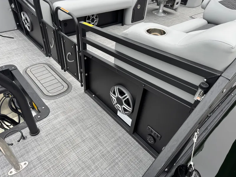 Slide: The Image of 2025 JC Neptoon Sport 23TT DSL interior with gray seating and speaker system. - 23