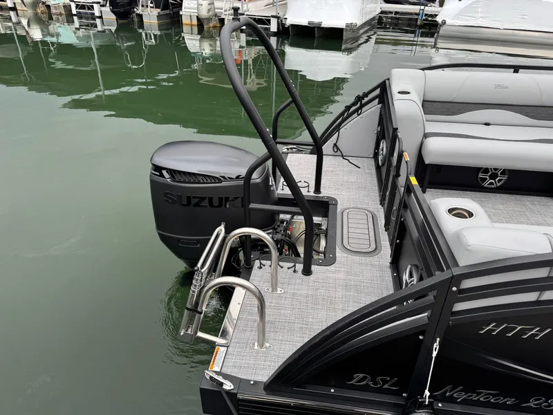 Slide: The Image of 2025 JC Neptoon Sport 23TT DSL pontoon boat with Suzuki outboard motor at dock. - 24