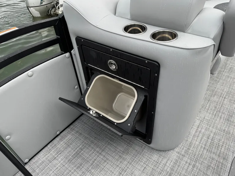 Slide: The Image of 2025 JC Neptoon Sport 23TT DSL boat interior with cup holders and storage compartment. - 5