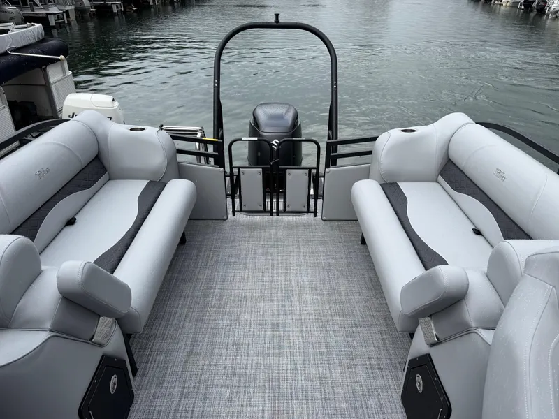 Slide: The Image of 2025 JC Neptoon Sport 23TT DSL pontoon boat interior with gray seating and water view. - 7