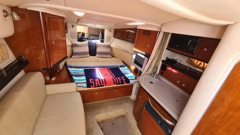 Slide: The Image of Interior of 2007 Sea Ray 290 Sundancer yacht with cozy seating and kitchenette. - 10