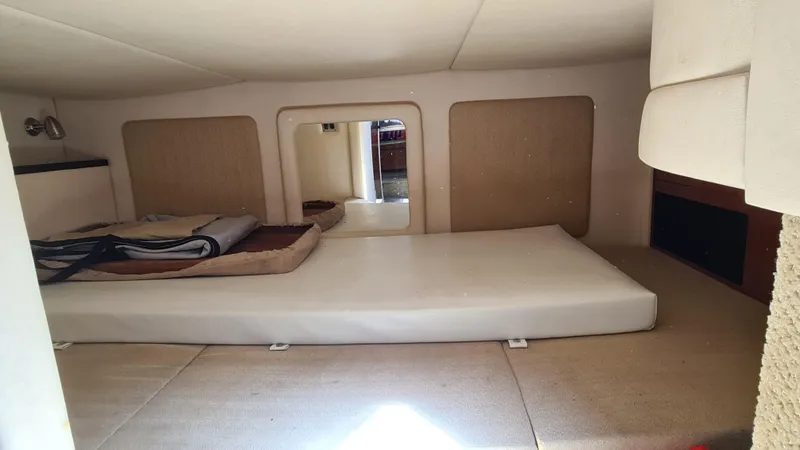 Slide: The Image of Interior cabin of 2007 Sea Ray 290 Sundancer with bed and storage space. - 17
