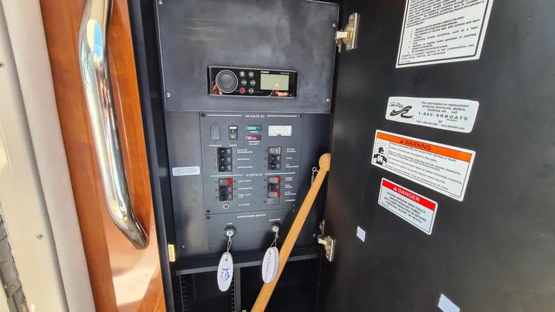Slide: The Image of Electrical panel of 2007 Sea Ray 290 Sundancer boat with control switches and labels. - 18