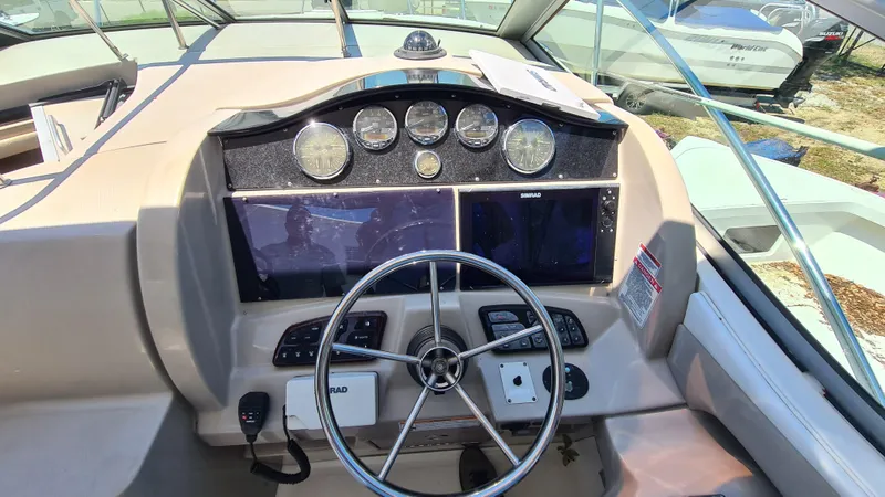 Slide: The Image of 2007 Sea Ray 290 Sundancer helm with steering wheel and instrument panel. - 20