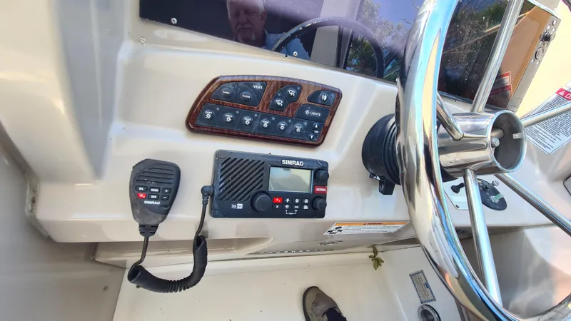 Slide: The Image of Control panel of a 2007 Sea Ray 290 Sundancer boat with steering wheel and radio. - 21