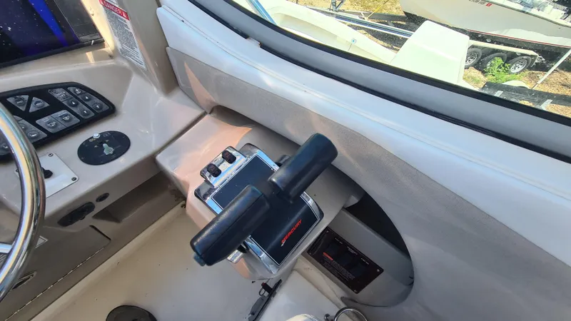 Slide: The Image of 2007 Sea Ray 290 Sundancer helm controls and dashboard view. - 25