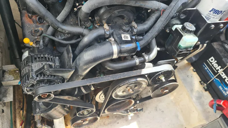 Slide: The Image of Engine compartment of a 2007 Sea Ray 290 Sundancer boat, showing belts and hoses. - 31