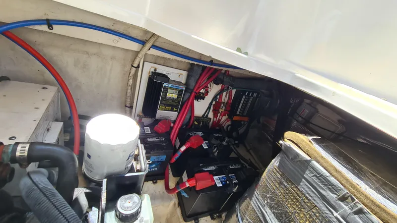 Slide: The Image of Engine compartment of a 2007 Sea Ray 290 Sundancer with visible batteries and wiring. - 34