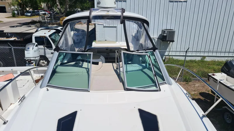 Slide: The Image of 2007 Sea Ray 290 Sundancer boat with open windshield, docked outdoors. - 5