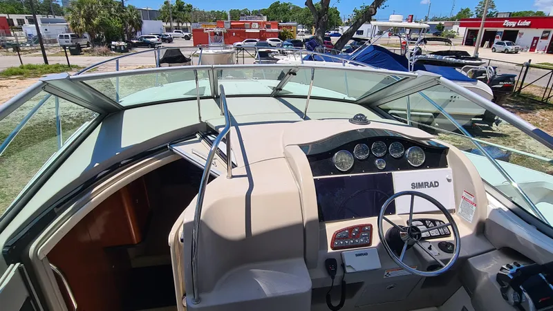 Slide: The Image of 2007 Sea Ray 290 Sundancer boat cockpit with steering wheel and navigation instruments. - 6