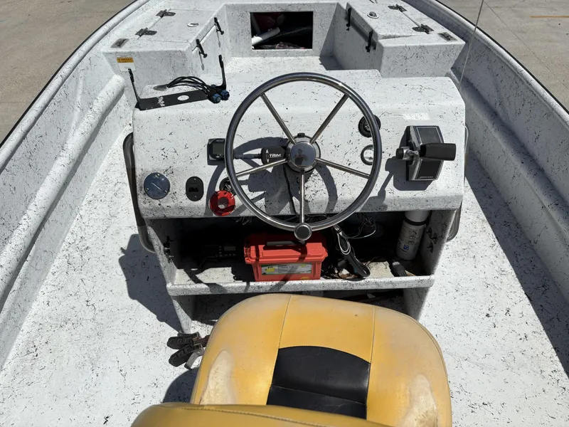 Slide: The Image of 2011 Skiff Reno 22 boat dashboard with steering wheel and controls. - 5