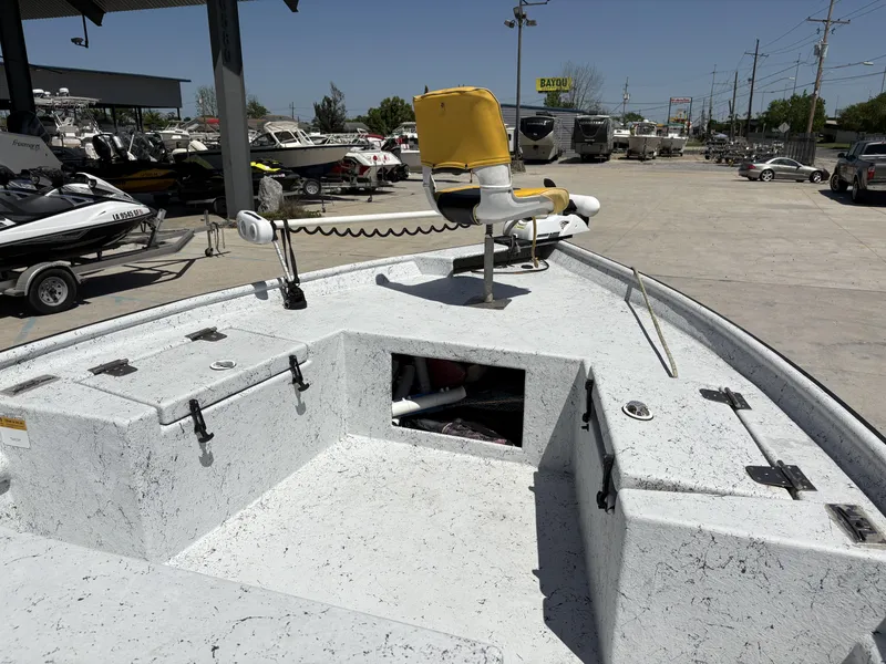 Slide: The Image of 2011 Skiff Reno 22 boat with yellow seat, parked in a marina with other boats. - 6