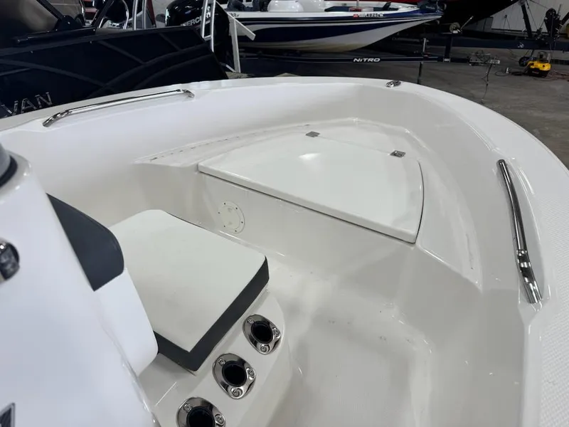 Slide: The Image of 2025 Robalo R160 Center Console boat interior with seating and storage compartments. - 4
