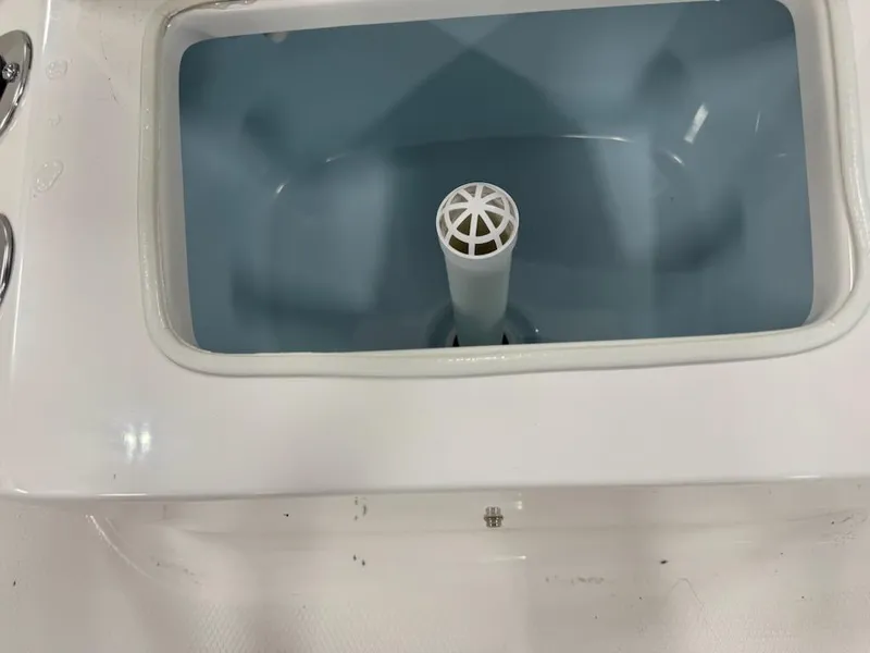 Slide: The Image of 2025 Robalo R160 Center Console livewell interior with drain pipe. - 9