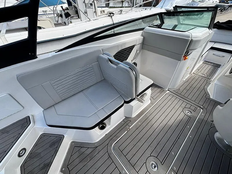 Slide: The Image of 2022 Sea Ray SPX 230 boat interior with gray seating and sleek design. - 11