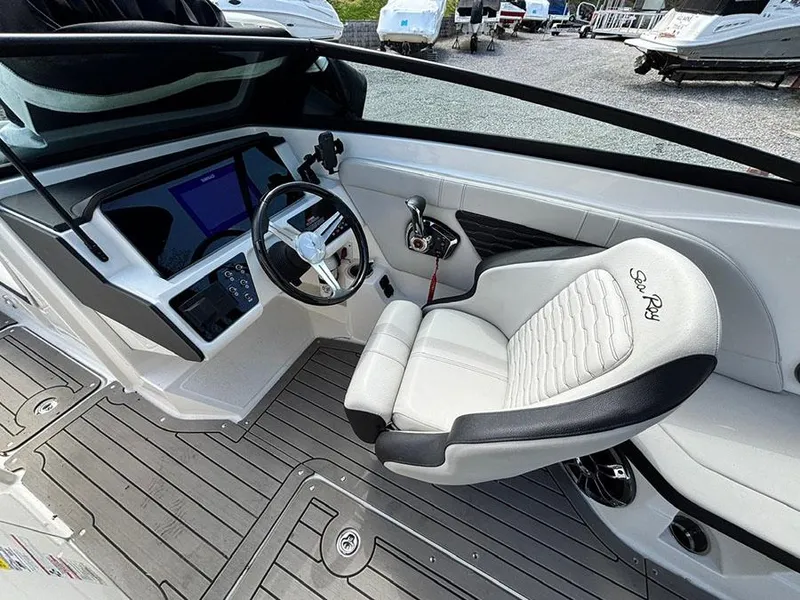 Slide: The Image of 2022 Sea Ray SPX 230 boat cockpit with steering wheel and control panel. - 12