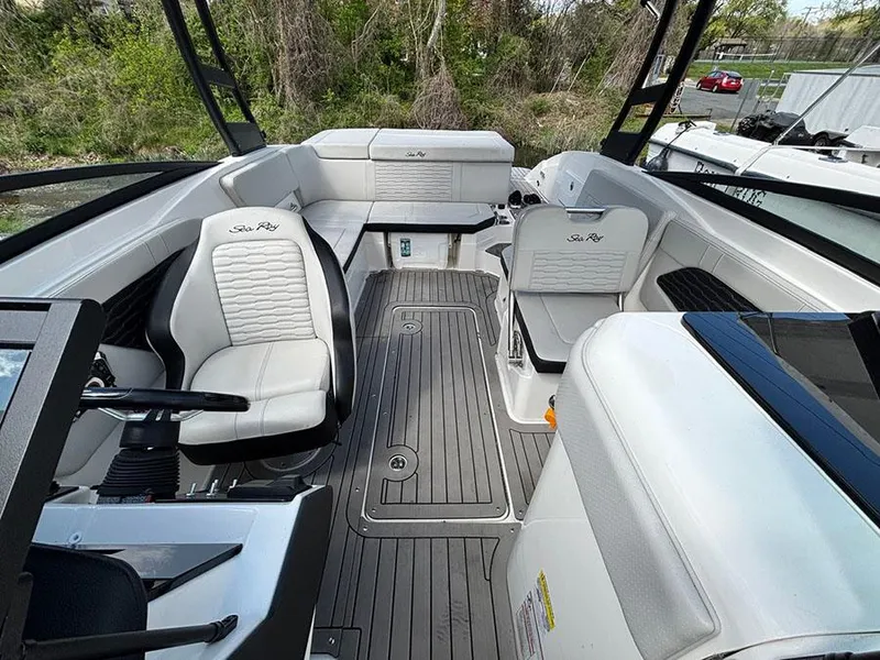 Slide: The Image of 2022 Sea Ray SPX 230 boat interior with white seating and sleek design. - 15