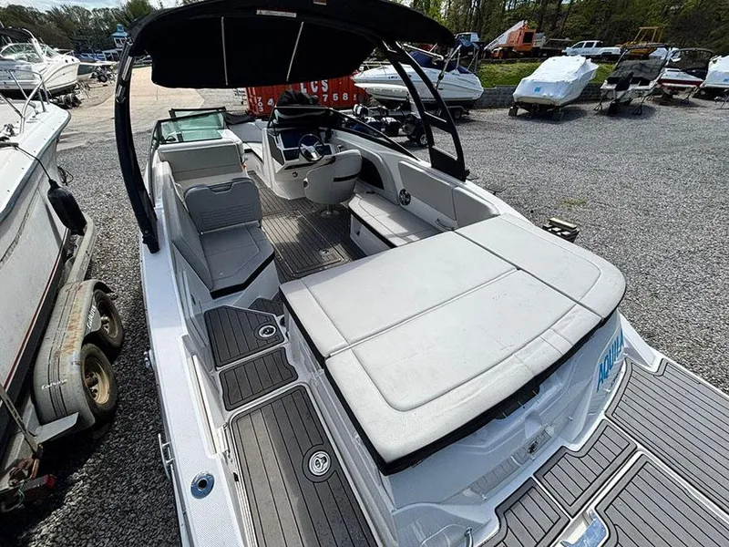 Slide: The Image of 2022 Sea Ray SPX 230 boat with spacious seating and sleek design, docked outdoors. - 4