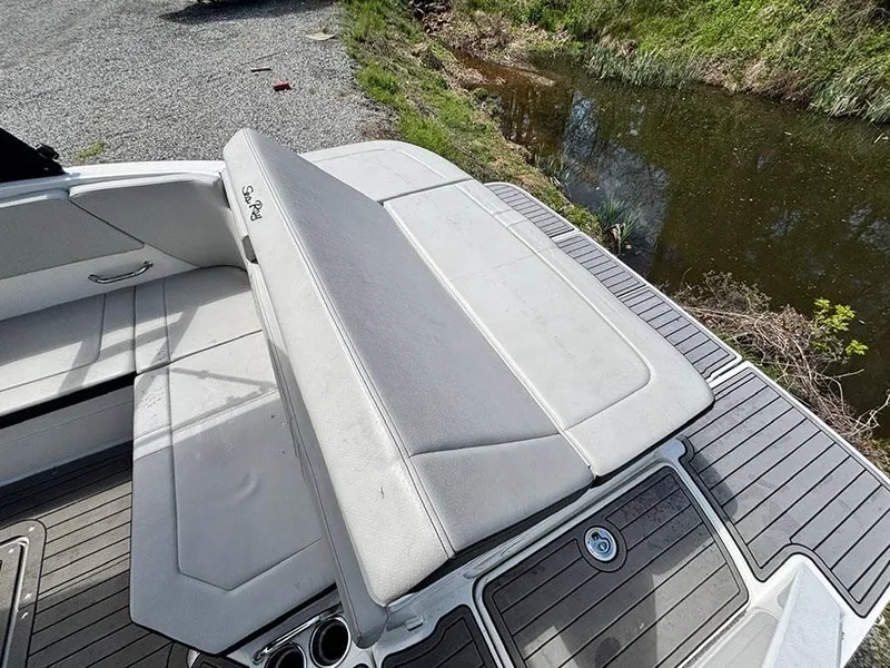 Slide: The Image of 2022 Sea Ray SPX 230 boat interior with cushioned seating and sleek design. - 7